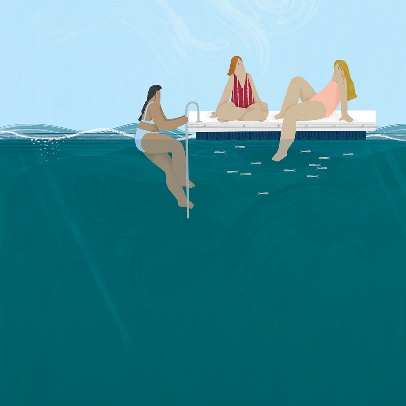 May include: Three people are relaxing on a floating dock in the water. The dock is white and has a blue border. The water is a deep teal color. There are small fish swimming in the water.