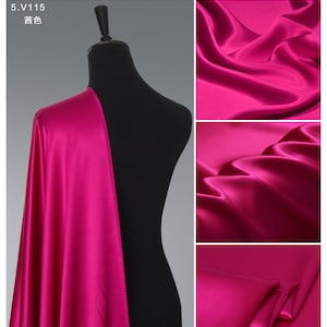 May include: A vibrant fuchsia pink satin fabric draped over a black mannequin. The fabric is smooth and silky, with a luxurious sheen. Close-up images show the texture and drape of the fabric.