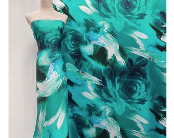 May include: A turquoise blue fabric with a large-scale abstract floral print. The print features white brushstrokes and dark green accents.
