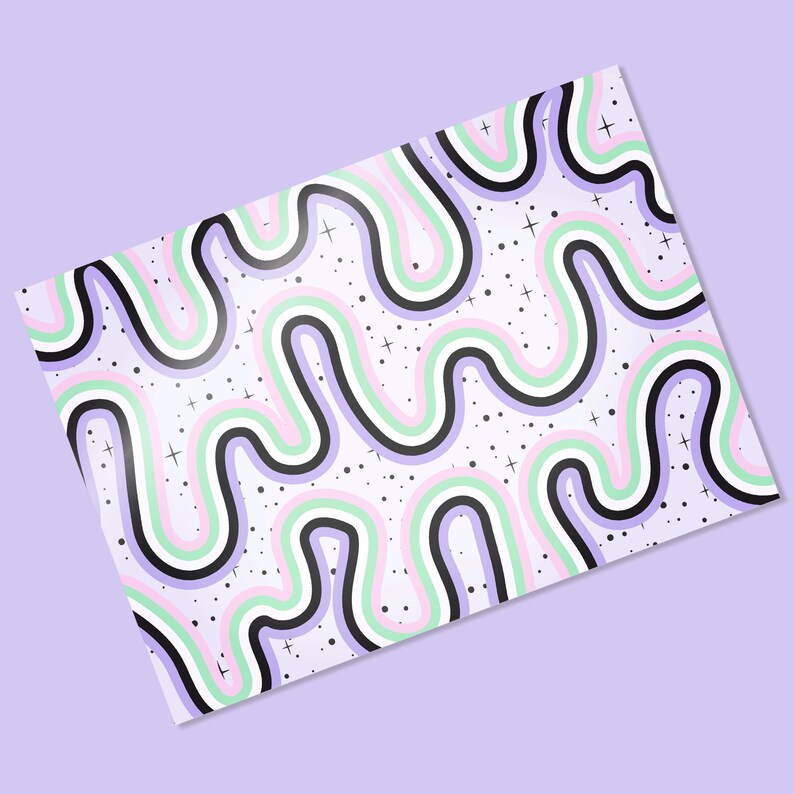 May include: A patterned sheet with a repeating wavy design in black, white, light green, pink, and purple. Small black dots and white crosses are scattered across the white background. The sheet is angled on a light purple surface.
