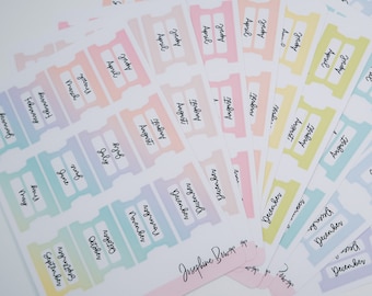 May include: A set of colorful monthly planner tabs with ombre shading. The tabs are labeled with the months of the year, starting with January and ending with December. The tabs are designed to be used in a planner or journal.