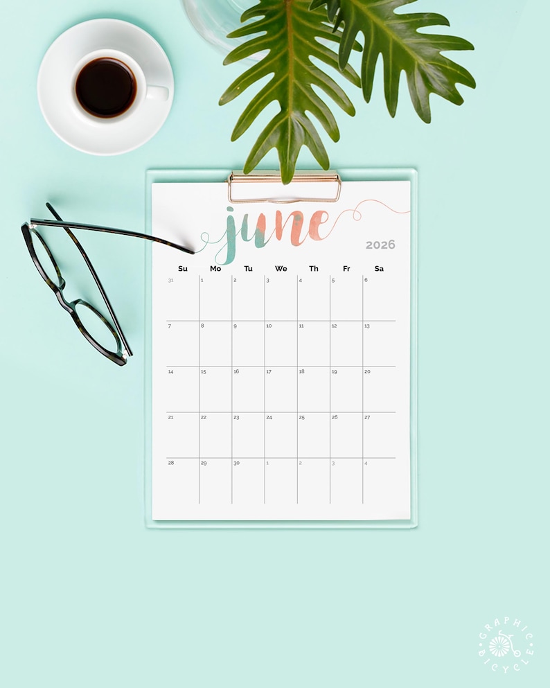May include: A clipboard calendar for June 2026 with a watercolor-style "June" header in teal and coral. The calendar is on a light blue background, with a cup of coffee, glasses, and a green plant.