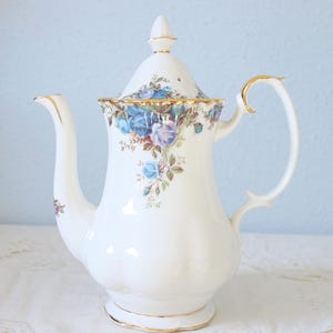 Op de afbeelding: Een set van drie keramische mokken met een gespikkelde, matte afwerking. De mokken zijn in tinten crème, lichtgrijs en donkergrijs. Elke mok heeft een eenvoudig, minimalistisch ontwerp, perfect voor koffie of thee.