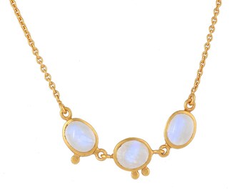 May include: A gold chain necklace with three oval-shaped moonstone pendants.