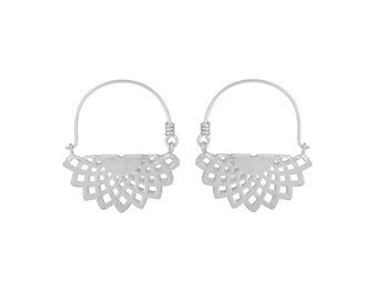 May include: A pair of silver earrings. Each earring has a half-circle design with an openwork fan shape. The earrings are a simple, elegant style, suitable for everyday wear or special occasions. The earrings are made of a silver-colored metal.