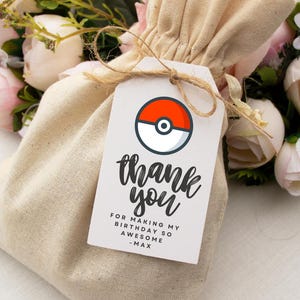 May include: White thank you tag with a red and white Pokeball graphic. The tag says "thank you" in black script and "For making my birthday so awesome - Max".