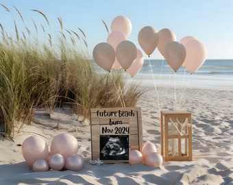 May include: A wooden sign with the text "Future Beach Bum Nov 2024" and an ultrasound image. The sign is surrounded by light pink balloons on a sandy beach.