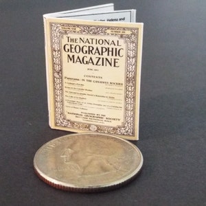 May include: A miniature replica of a vintage National Geographic Magazine from June 1921. The cover features the title "The National Geographic Magazine" and the text "CONTENTS:  Exploring in the Canadian Rockies".