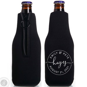 May include: Black neoprene bottle cooler with a zipper closure and a white circle design that says "Emily & Pete Hayes August 21, 2021".