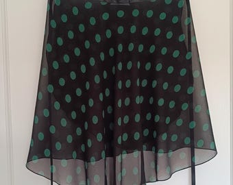 May include: A black and green polka dot chiffon dance skirt with a ruffled hem and black ribbon ties.