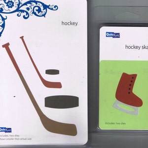 May include: Two QuickKutz die cut sets. One set features hockey sticks and a puck, the other a hockey skate. The hockey set is on a white background, the skate set on green. Each set includes two dies.