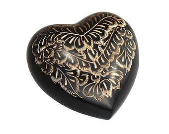 May include: Black heart-shaped wooden box with a gold floral design.
