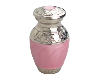 May include: A small pink cremation urn with a silver lid and engraved floral design.