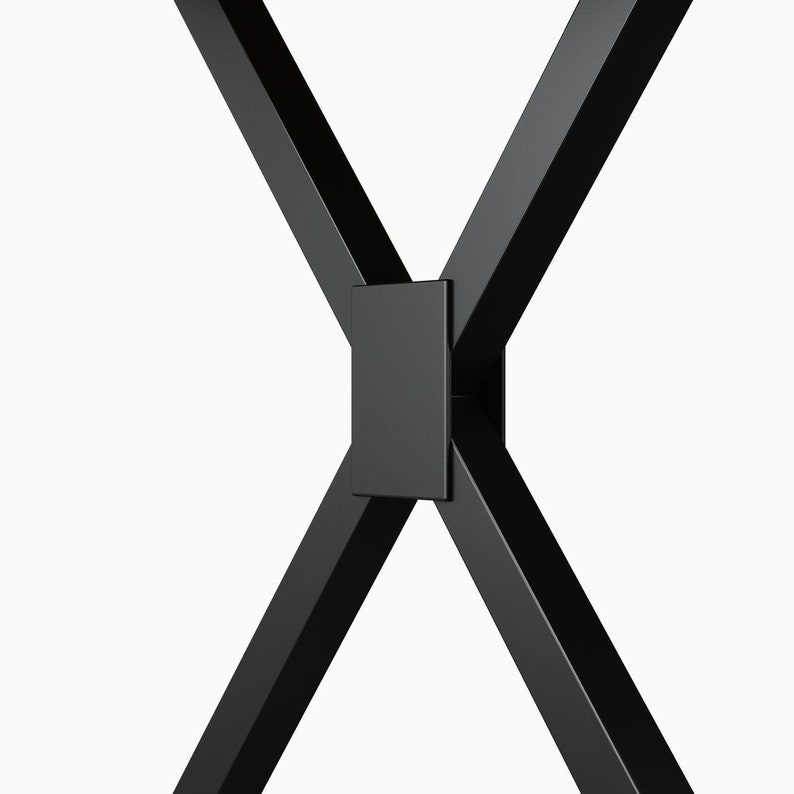 May include: Close-up of a black metal table leg with a square metal plate connecting the legs.