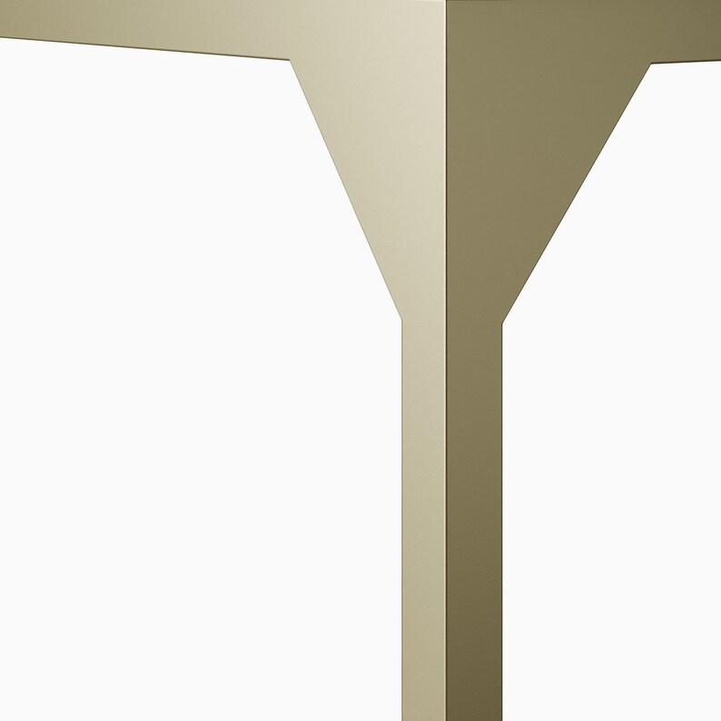 May include: Close-up of a table leg made of a light brown wood. The leg has a unique, angled design.