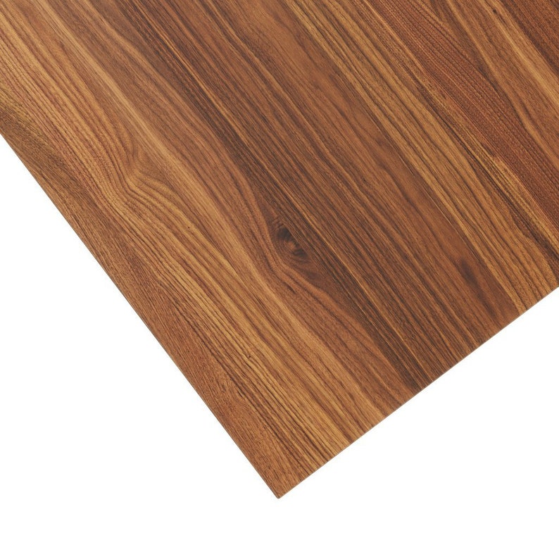 May include: Close-up of a woodgrain laminate sheet with a warm brown color and a natural wood pattern.