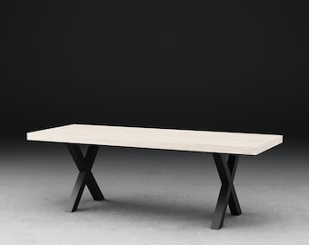 May include: A light wood dining table with a black X-shaped base.