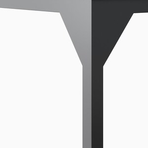 May include: Close-up of a table leg with a gray and black finish. The leg is made of two pieces of wood that are joined together at a 90-degree angle.
