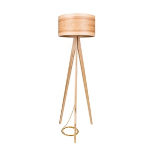 May include: A wooden tripod floor lamp with a natural wood shade. The lamp has a gold cord.