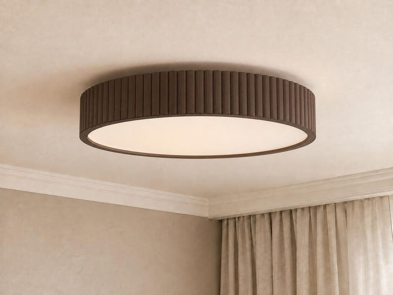 May include: A circular flush mount ceiling light fixture featuring a dark brown exterior frame with a vertical ribbed texture and a flat, circular white diffuser panel that emits a soft, even glow across the surface of the light fixture.