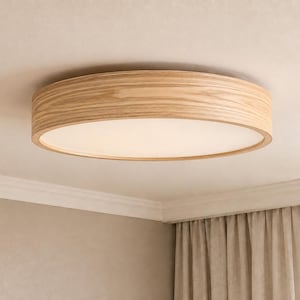 May include: A circular flush mount ceiling light fixture featuring a light-toned wood grain frame and a flat, opaque white diffuser panel that emits a soft, even glow across the surface of the light fixture when illuminated.