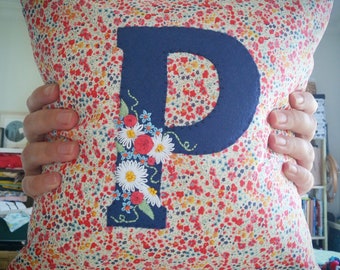 Personalised floral initial cushion.