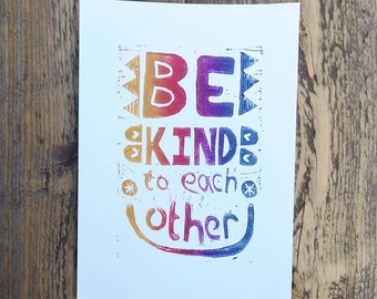 Be kind to each other linocut print in rainbow