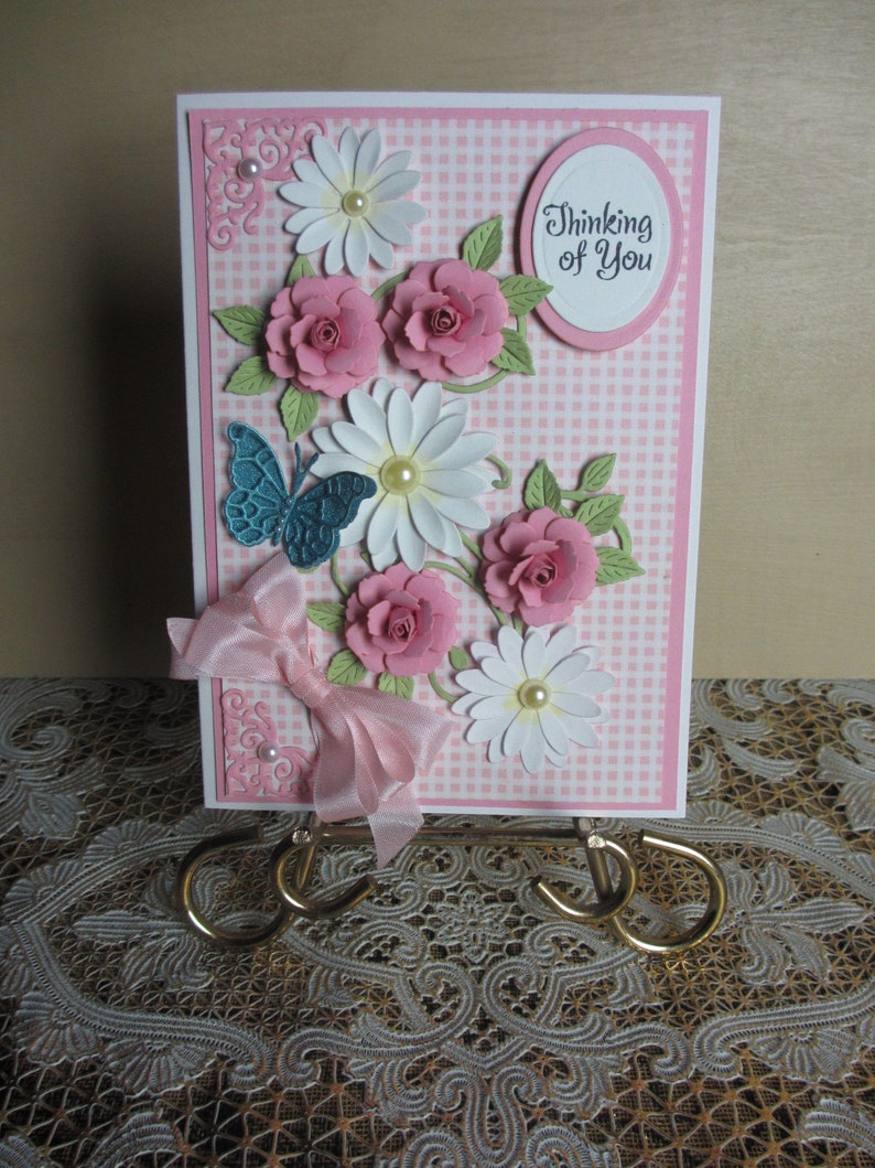 Handmade embellished pink gingham background with pink roses and white daisies thinking of you card with butterfly
