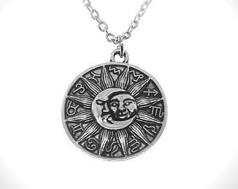 May include: A silver necklace with a round pendant featuring a sun with a face and zodiac symbols around the edge.
