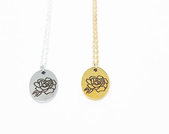 May include: Two delicate necklaces with a rose pendant. One necklace is silver with a silver rose pendant, and the other is gold with a gold rose pendant.
