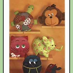 May include: A sewing pattern for six different pillow toys: a turtle, a monkey, a cat, an elephant, an owl, and a frog. The pattern is called Simplicity 9740 and is for one size.
