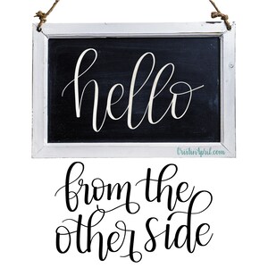 May include: A white framed chalkboard with the text "hello from the other side" written in black cursive script.