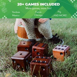 May include: A set of six large wooden dice in brown with black dots, sitting on green grass. The dice are used for playing various games, including Yardzee, Farkle, Pig, and more.