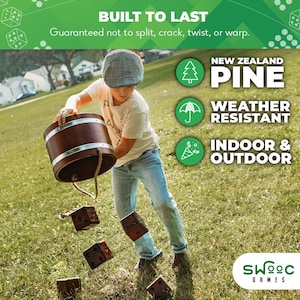 May include: A boy throws wooden dice into a wooden bucket. The dice are brown and have white dots. The bucket is brown with a metal band around the top. The boy is wearing a blue shirt, blue jeans, and a brown hat. The background is a green grassy field. The text on the image reads "BUILT TO LAST", "Guaranteed not to split, crack, twist, or warp.", "NEW ZEALAND PINE", "WEATHER RESISTANT", "INDOOR & OUTDOOR", and "SWOOC GAMES".
