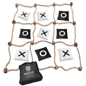 May include: A rope tic-tac-toe game with wooden posts and black and white bean bags. The bean bags have an X or O printed on them. The game comes with a black carrying bag with the word "SWOC Games" printed on it.