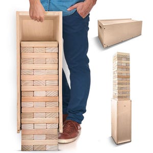 May include: A wooden block stacking game with a natural finish. The game includes a wooden box for storage and a tower of rectangular blocks. The blocks are arranged in alternating layers. The game is shown being held by a person.