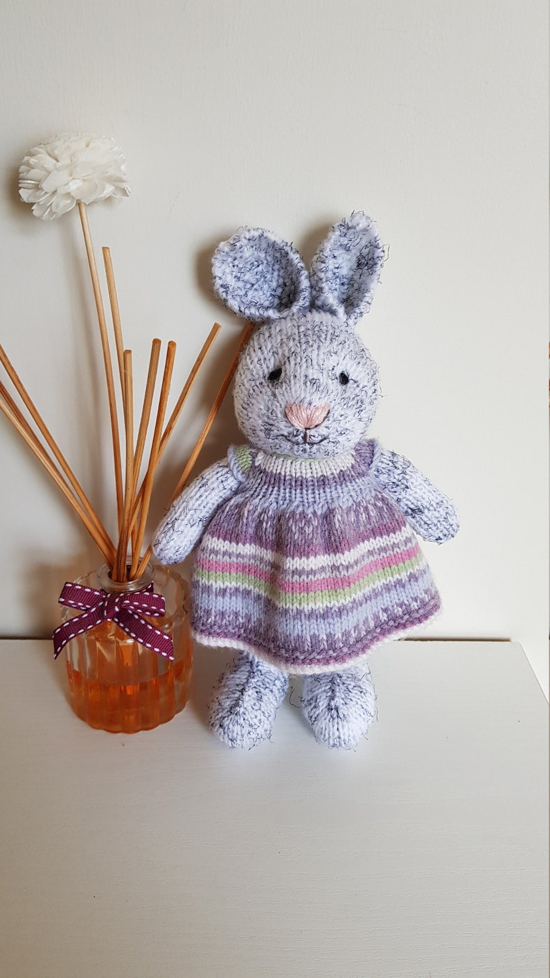 Harriet is eagerly awaiting adoption and can/'t wait to meet her new family Hand knitted bunny Multicolored dress Nursery prop.