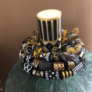Black, gold, and white Candle ring 10”