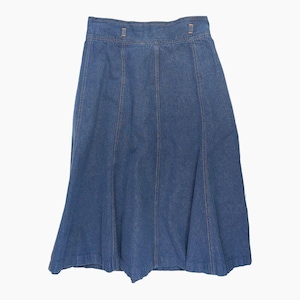 May include: A blue denim skirt with a flared A-line silhouette. The skirt features vertical seams and two small metal clasps at the waistband. The skirt is made of a medium-wash denim fabric.