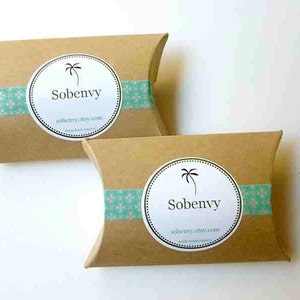 May include: Two brown cardboard pillow boxes with a teal and white patterned tape. Each box has a white circle sticker with a palm tree and the text "Sobenvy" and "sobenvy.etsy.com".