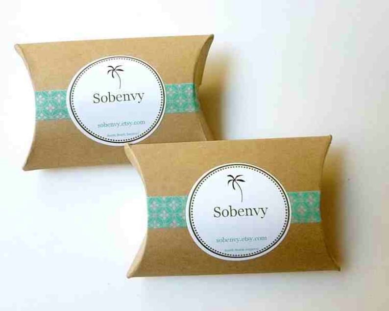 May include: Two brown cardboard pillow boxes with a teal and white patterned tape. Each box has a white circle sticker with a palm tree and the text "Sobenvy" and "sobenvy.etsy.com".