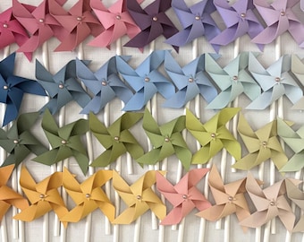 Mini spinning pinwheels in a gradient of colors with rose gold center brads