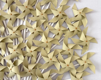 Mini spinning pinwheels in golden sage, red wine and creamy beige with gold center brads