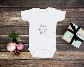 Download Christmas Baby Girl Bodysuit Mockup Bodysuit Mockup On Dark Wood Background Pregnancy Announcement Photo Do We Still Need Mockups For Website Designs