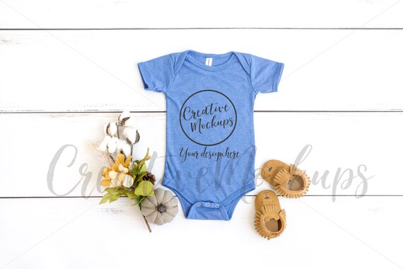 Bella Canvas Heather Colum Blue Bodysuit Mockup On Wood