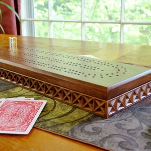 Carved walnut 2 track Cribbage board with storage for pegs and cards