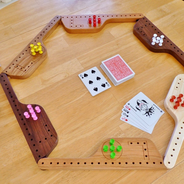 Pegs and Jokers game for 4, 6, or 8 players with hardwood paddles and nice storage box