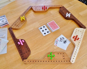 Pegs and Jokers game for 4, 6, or 8 players with hardwood paddles and nice storage box