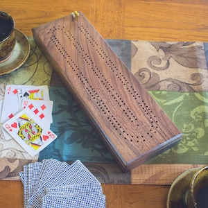 Walnut Cribbage board with 2 tracks and storage for pegs and cards