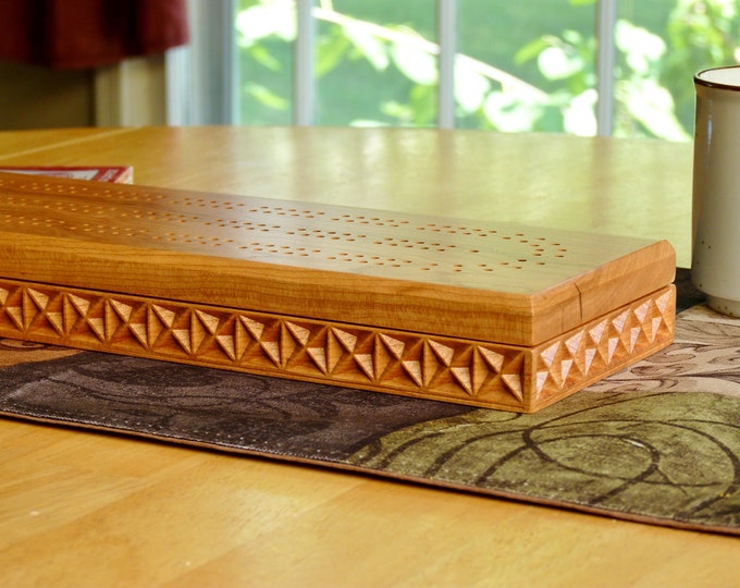 Carved cherry Cribbage board with 2 tracks and storage for pegs and cards